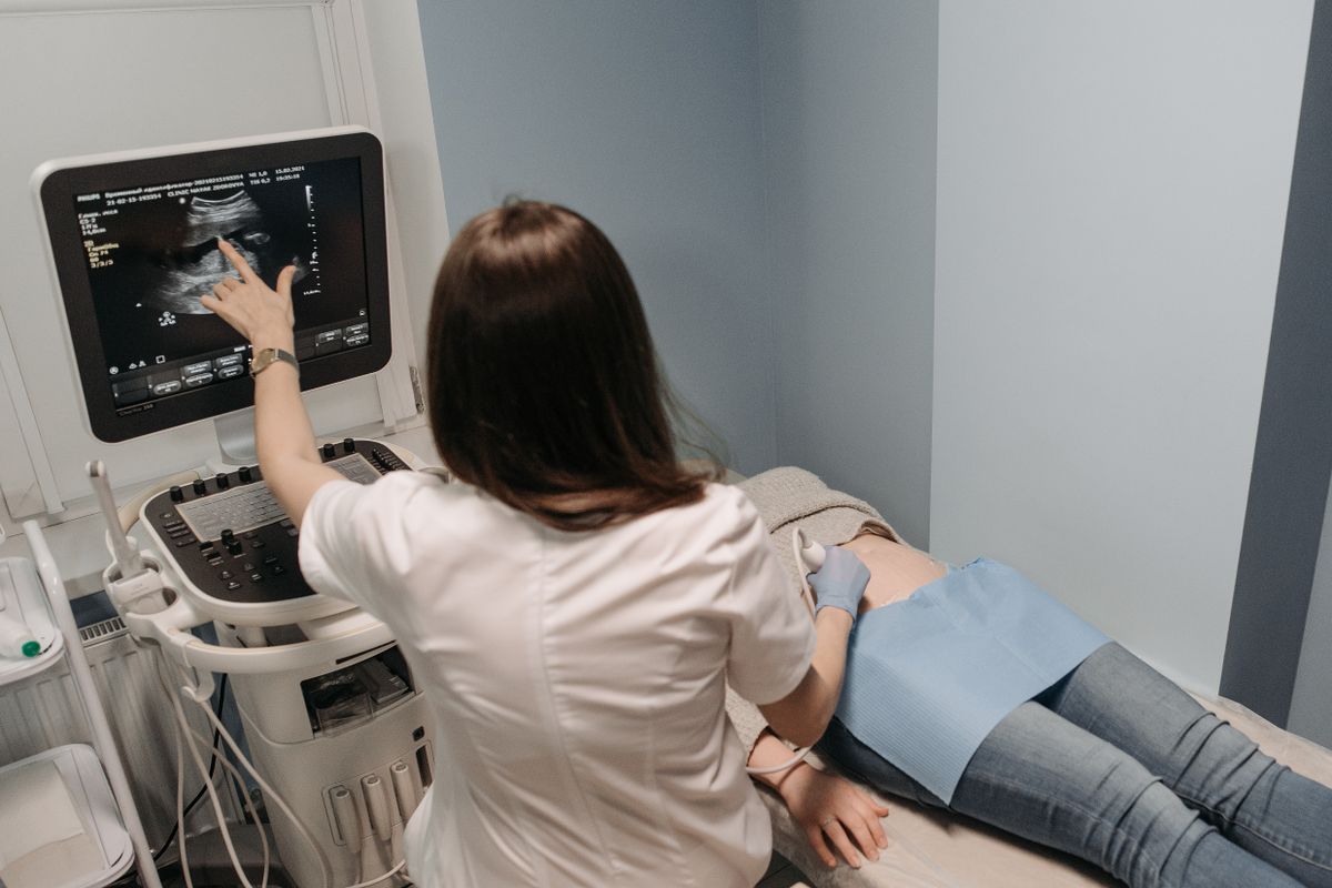 A clinician performing an abdominal ultrasound examination