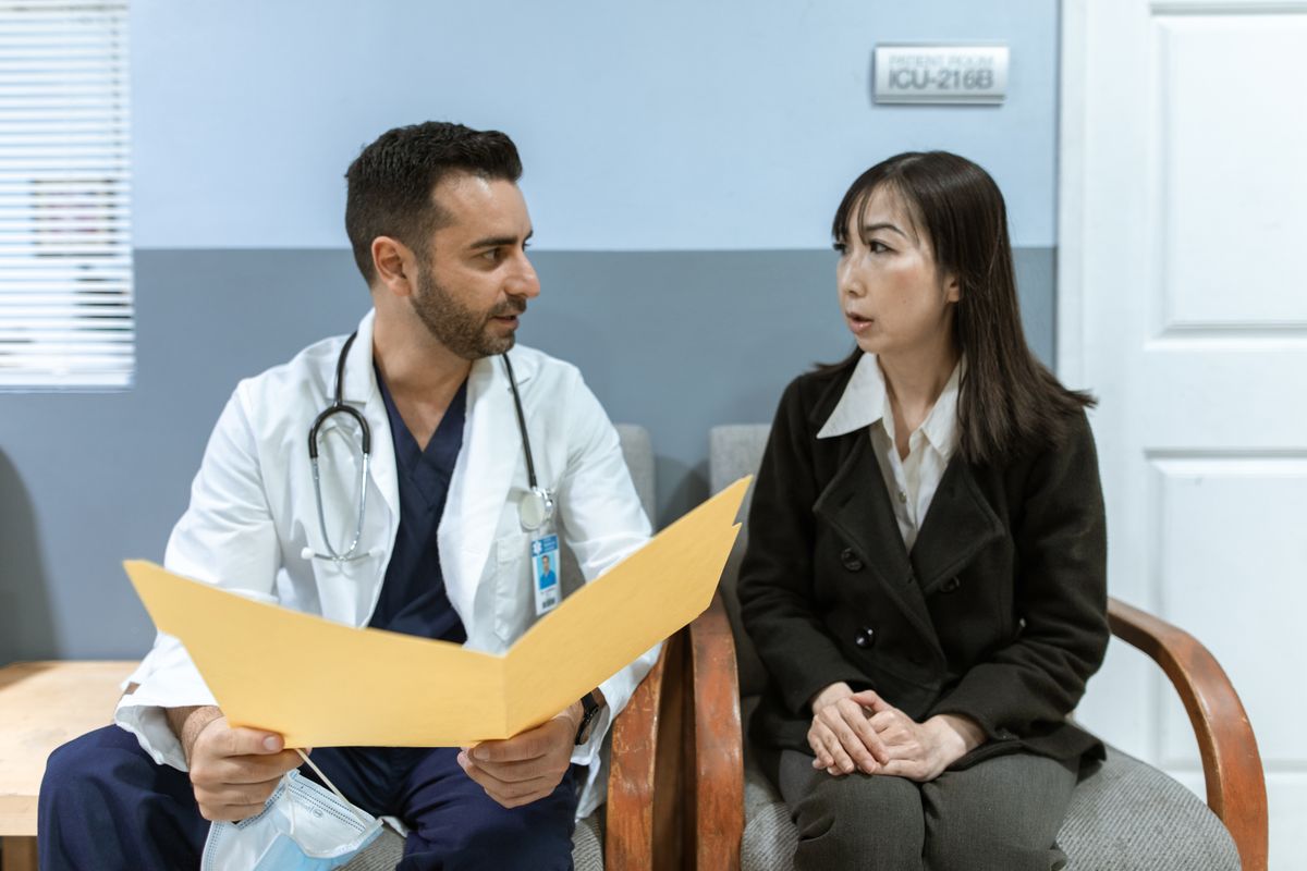 A healthcare professional consulting with a patient in a clinical setting