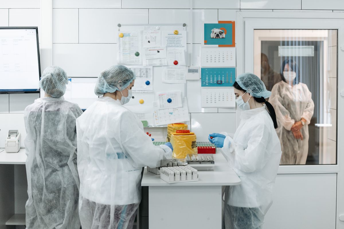 Medical researchers conducting experiments in a controlled laboratory environment