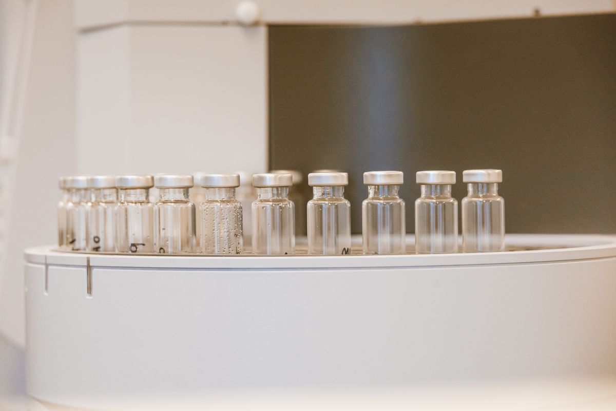 Empty glass vials arranged in rows in a laboratory