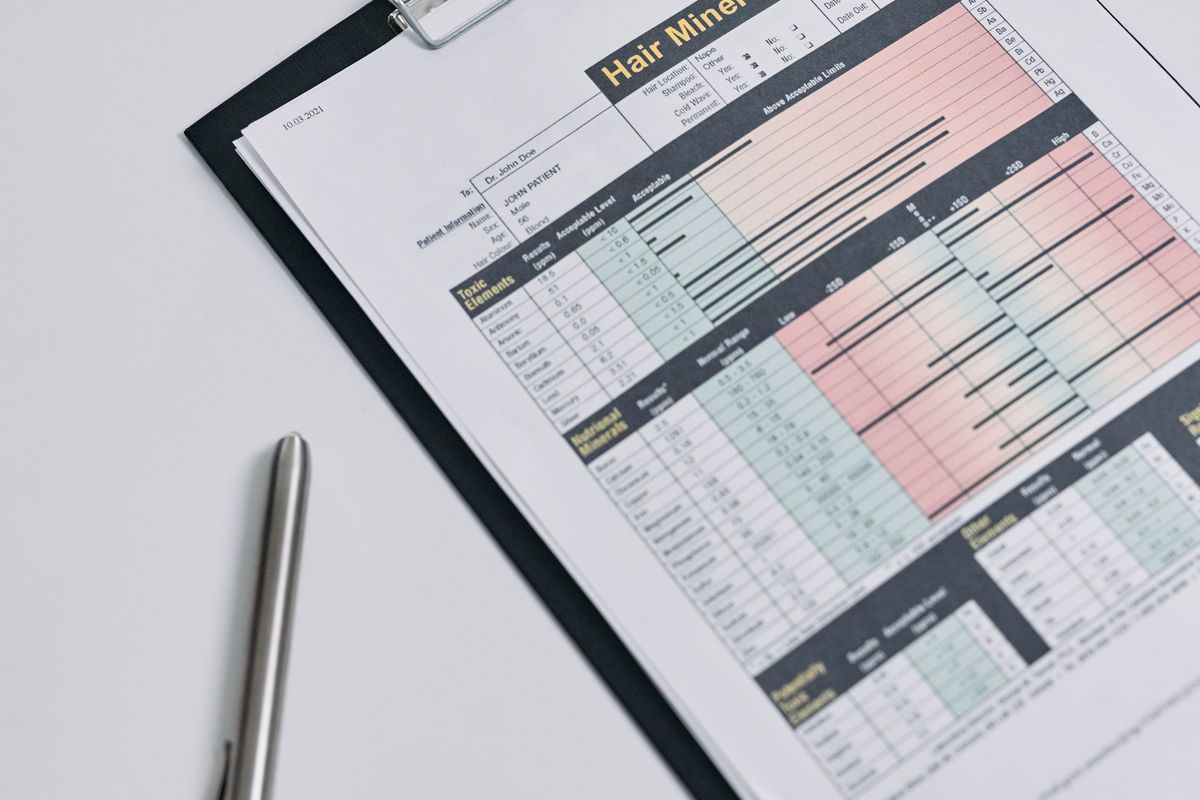 A printed laboratory analysis report on a clipboard, photographed from above