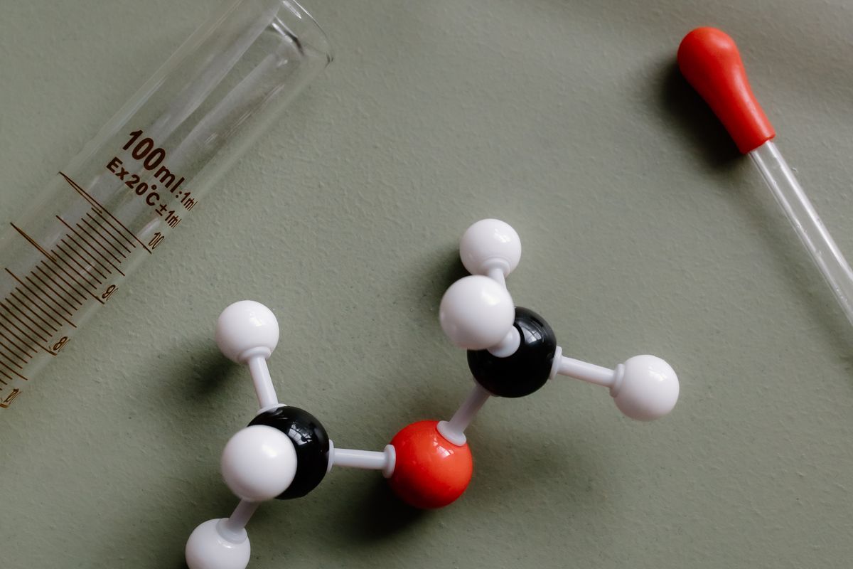 A molecular model surrounded by laboratory equipment