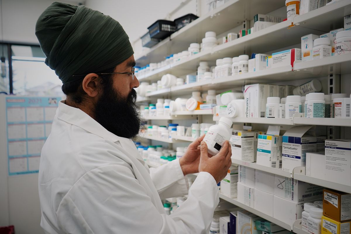 A pharmacist organising shelves in a pharmacy