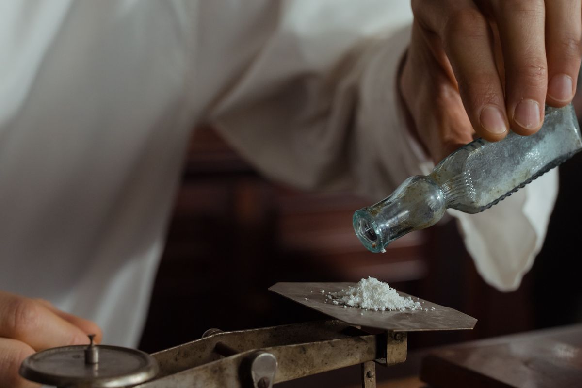 A white powder being weighed on a balance pan